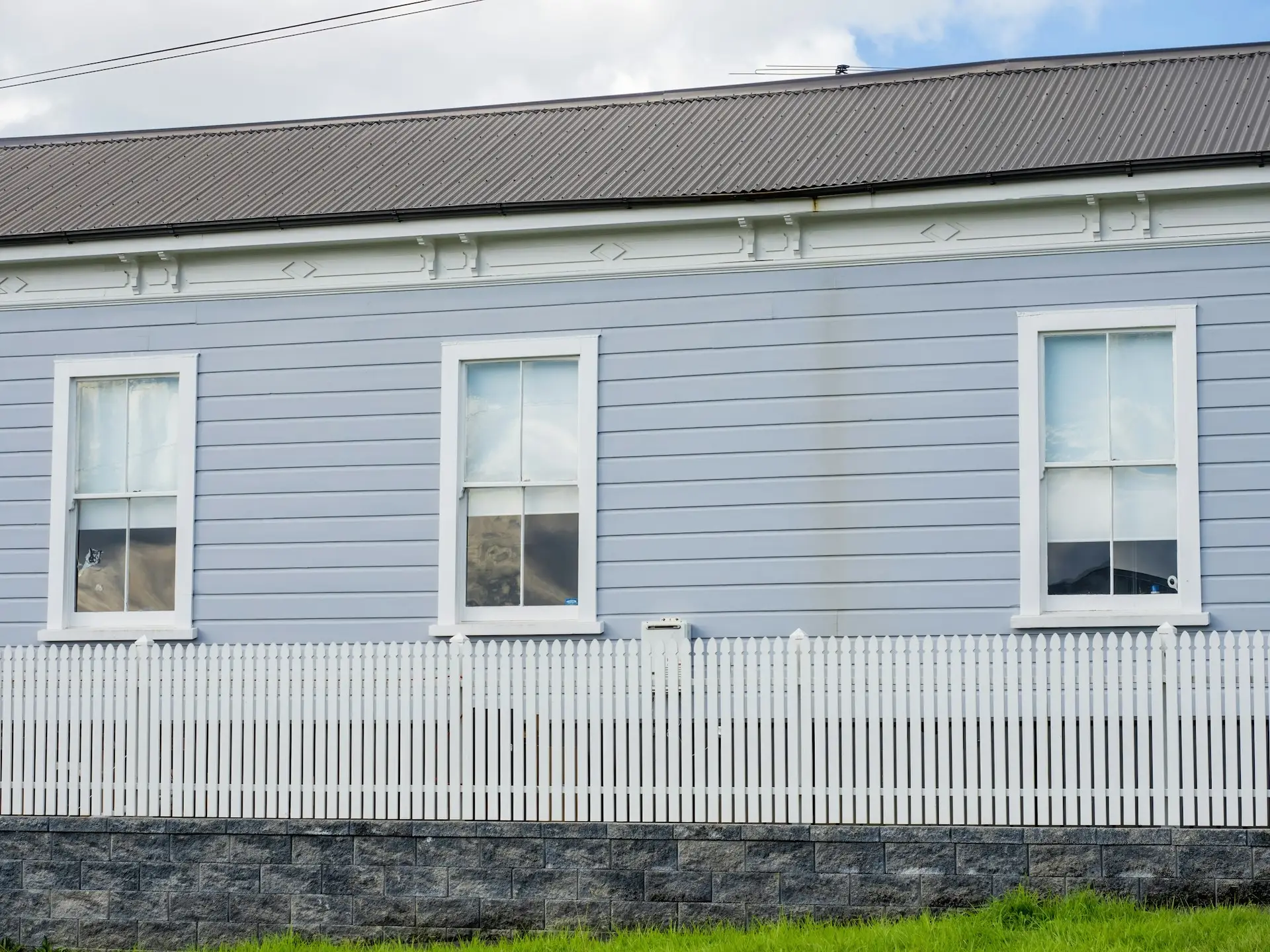 windows on timer weatherboard wall